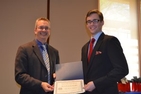 Dean James Goldgeier presents the Alan Taylor Award to David Parker, SIS/MA '13.